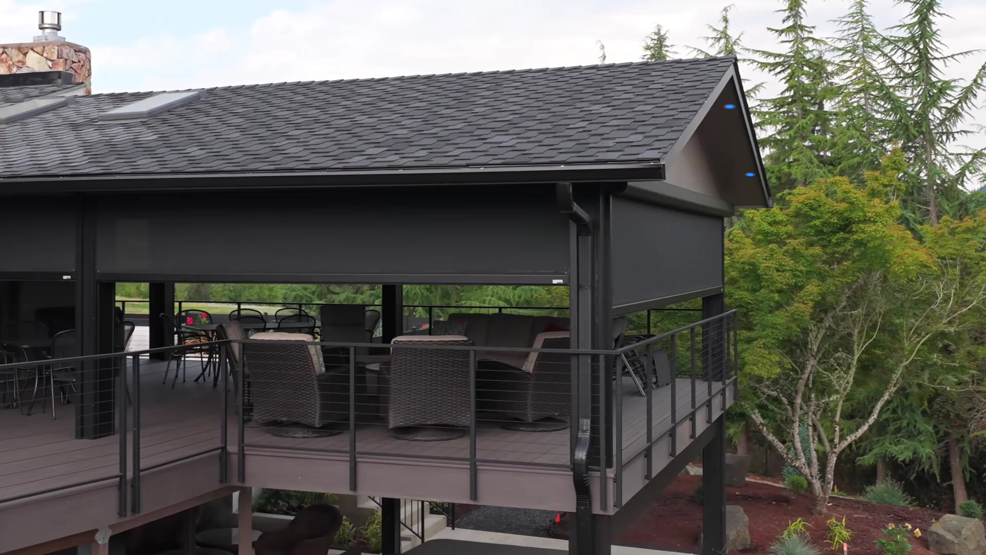 Aerial view of Oregon home with Fenetex motorized screens installed on covered deck